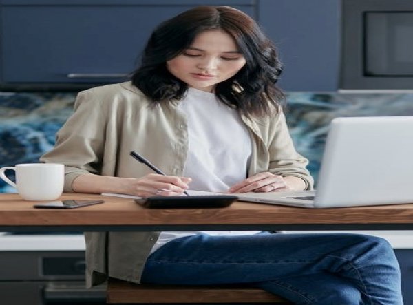 A Chinese girl writing on a notebook